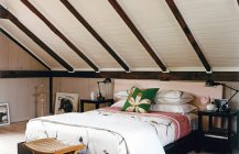 Дизайн деревенской спальни в светлых цветах на чердаке  
